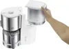 A hand is shown removing the water reservoir from a coffee maker. Produktbild-Vorschau