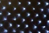 A close-up view of a string of white LED lights against a dark background. Produktbild-Vorschau