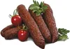 A group of sausages with cherry tomatoes and parsley on a white background. Náhled obrázku produktu
