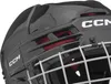 A close-up view of a black hockey helmet with silver cage and red accents. Náhľad obrázku produktu