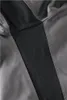 A close-up view of a garment, showing a textured panel inset into a smooth fabric. Produktbild-Vorschau