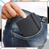 A hand is placing a small black notebook into the pocket of a pair of blue jeans. Náhľad obrázku produktu