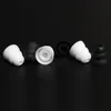 A collection of black and white silicone earbud tips arranged on a black background. Podgląd zdjęcia produktu