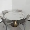 A round dining table with four chairs in a room. Produktbild-Vorschau