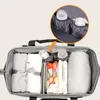 An overhead view of an open diaper bag, showcasing its organized interior with various baby essentials. Náhľad obrázku produktu