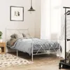 A bedroom scene with a metal bed frame, bedding, a nightstand, and a clothing rack. Voir les images du produit