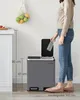 A person is shown using a dual-compartment kitchen trash can, with dimensions indicated by measurement lines. Produktbild-Vorschau