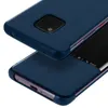 A close-up, angled view of a dark blue flip cover for a Huawei Mate 20 Pro, showing the camera module on one side and the smart view window on the other. Anteprima dell’immagine prodotto