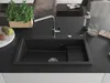 A black granite kitchen sink with a chrome faucet and accessories on a black countertop. Produktbild-Vorschau