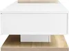 A close-up side view of a modern coffee table with a white drawer and a wood-grain base. Voir les images du produit