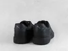 The back view of a pair of black Puma sneakers against a light gray and white textured background. Produktbild-Vorschau