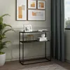 A console table with decorative items and artwork on the wall.