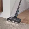 A vacuum cleaner head with lights is cleaning a carpet next to a wooden floor. Voir les images du produit