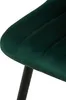 A close-up view of a green velvet chair seat and a black leg. Anteprima dell’immagine prodotto
