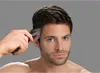 A man is using a hair clipper on his head. Anteprima dell’immagine prodotto
