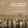 Close-up of a taupe jersey fitted sheet, highlighting its texture and elastic edge, with marketing text about its softness and material. Produktbild-Vorschau