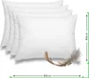 A set of four white pillows are arranged diagonally, with a feather in the foreground. Náhled obrázku produktu