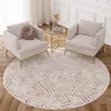 Two cream armchairs are placed on a round rug with a geometric pattern in a living room setting. Náhled obrázku produktu