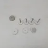 Various small hardware components, likely for a baby gate or similar safety device, are laid out on a light gray surface. Produktbild-Vorschau