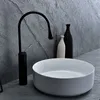 A modern bathroom sink and faucet set against a slate-like wall. Anteprima dell’immagine prodotto