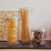 Three glass jars filled with pasta and beans on a shelf. Produktbild-Vorschau