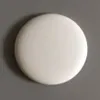 A simple product shot of a white, round object on a gray background. Produktbild-Vorschau