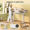 A woman is carrying books and placing them on a white standing desk in a room with yellow walls and a window. Produktbild-Vorschau