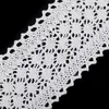 A close-up of white lace trim against a black background. Produktbild-Vorschau