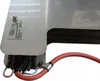 A close-up view of an electrical component with wires and a red cable attached. Náhled obrázku produktu