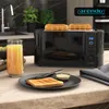 A black toaster with toast in it, a glass of orange juice, and a plate with toast and butter on a kitchen counter. Náhľad obrázku produktu