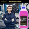A mechanic stands in a workshop next to a car, holding a bottle of coolant. Produktbild-Vorschau