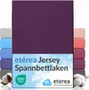 A stack of folded jersey bed sheets in various colors, with the main product in a deep purple color prominently displayed. Produktbild-Vorschau