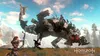 A woman with a bow and arrow faces a large robotic creature in a grassy, mountainous landscape. Produktbild-Vorschau