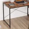 A close-up view of a desk with a laptop, notebook, and headphones. Podgląd zdjęcia produktu