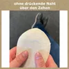 A person is holding up a sock, showing the toe seam, with their legs and shoes in the background. Produktbild-Vorschau
