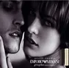 A close-up marketing image of a man and a woman's faces, with two perfume bottles in the foreground. Podgląd zdjęcia produktu