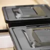 Two black storage boxes with lids are shown in a close-up shot. Anteprima dell’immagine prodotto