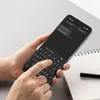A person's hands are holding a smartphone with a keyboard displayed, suggesting interaction or typing. Produktbild-Vorschau