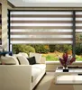 A living room with a sofa and a coffee table, with a large window showing a natural landscape. Náhled obrázku produktu