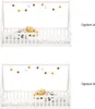 Two identical white wooden children's beds with a garland of felt balls above them, each with a stuffed animal on the mattress. Produktbild-Vorschau