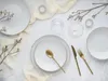 A table setting with plates, cutlery, and decorative elements. Náhľad obrázku produktu