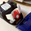 A close-up view of the inside of a vacuum cleaner, showing a dust bag and a filter. Produktbild-Vorschau
