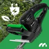 A close-up of an electric hedge trimmer against a background of lush green trees and a green overlay. Náhľad obrázku produktu