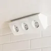 A white multi-outlet power strip mounted under a white countertop, with a white tiled backsplash behind it. Produktbild-Vorschau
