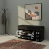 A shoe cabinet with a bench seat in a room with a coat rack and a painting on the wall. Náhľad obrázku produktu