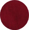 A circular, red, shaggy rug.