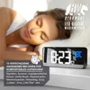 A woman sleeping peacefully next to a digital alarm clock displaying the time and temperature. Náhľad obrázku produktu