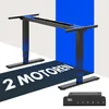 A black electric standing desk frame with blue accents, shown in a studio setting with a blue and white background. A separate control panel is shown in the foreground. Anteprima dell’immagine prodotto