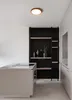 A modern kitchen with a sleek island and a black shelving unit. Produktbild-Vorschau