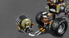 A close-up shot of a LEGO vehicle and a detached accessory, likely a weapon or tool, against a plain gray background. Produktbild-Vorschau
